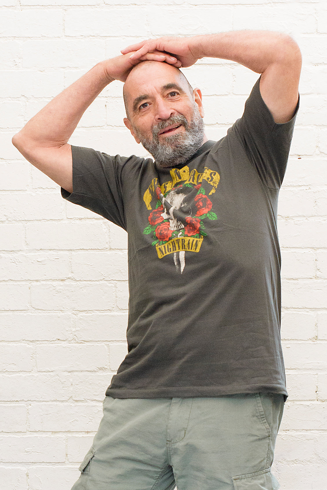 model wearing black cotton t-shirt with guns 'n' roses nightrain skull and roses graphic print on front