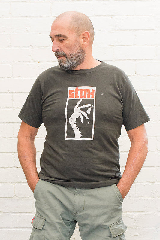model wearing black cotton t-shirt with stax record label logo printed on front