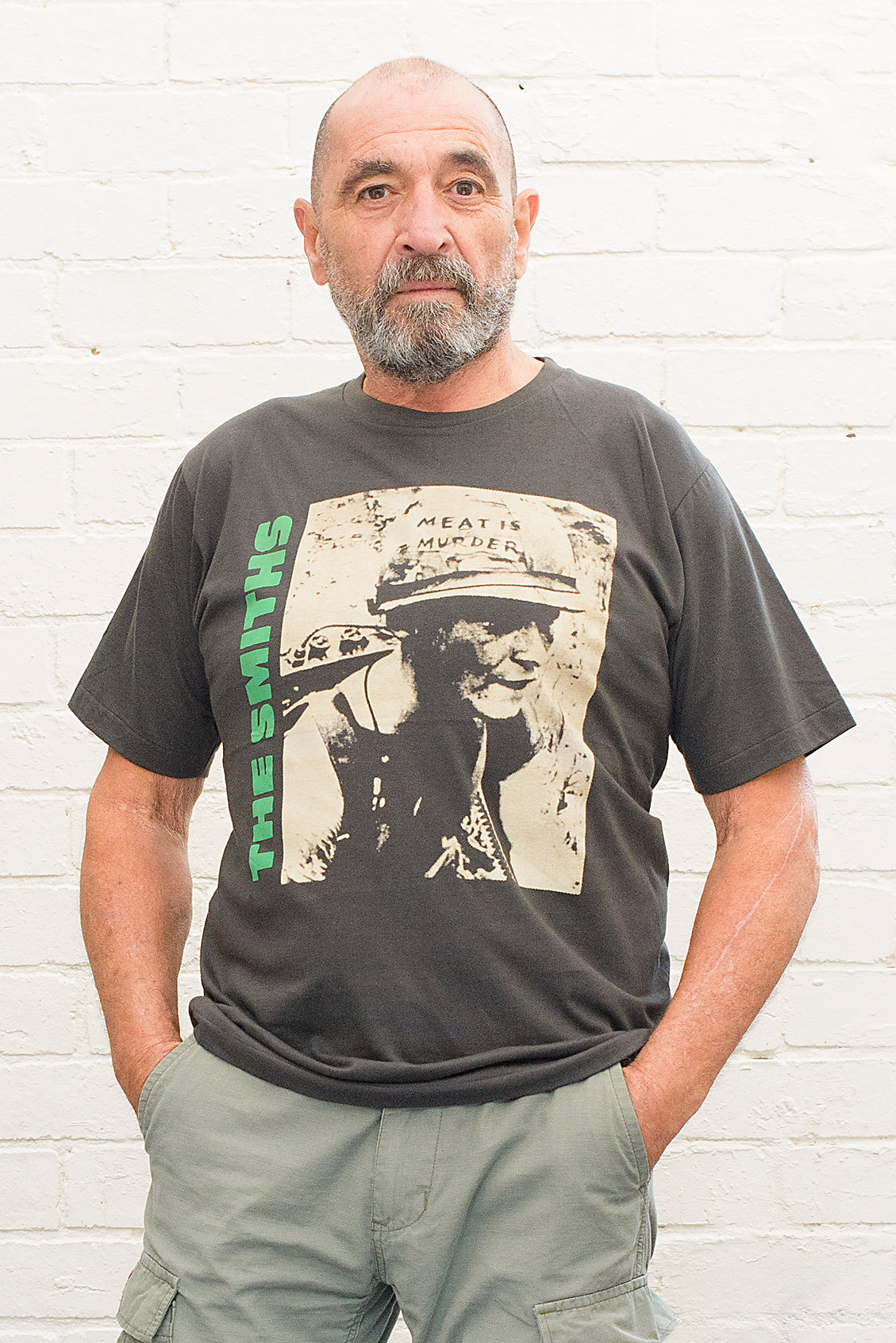 model wearing black cotton t-shirt with the smiths meat is murder album cover printed on the front