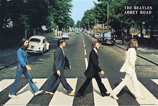 Album cover of 'Abbey Road' by The Beatles featuring four band members crossing Abbey Road.