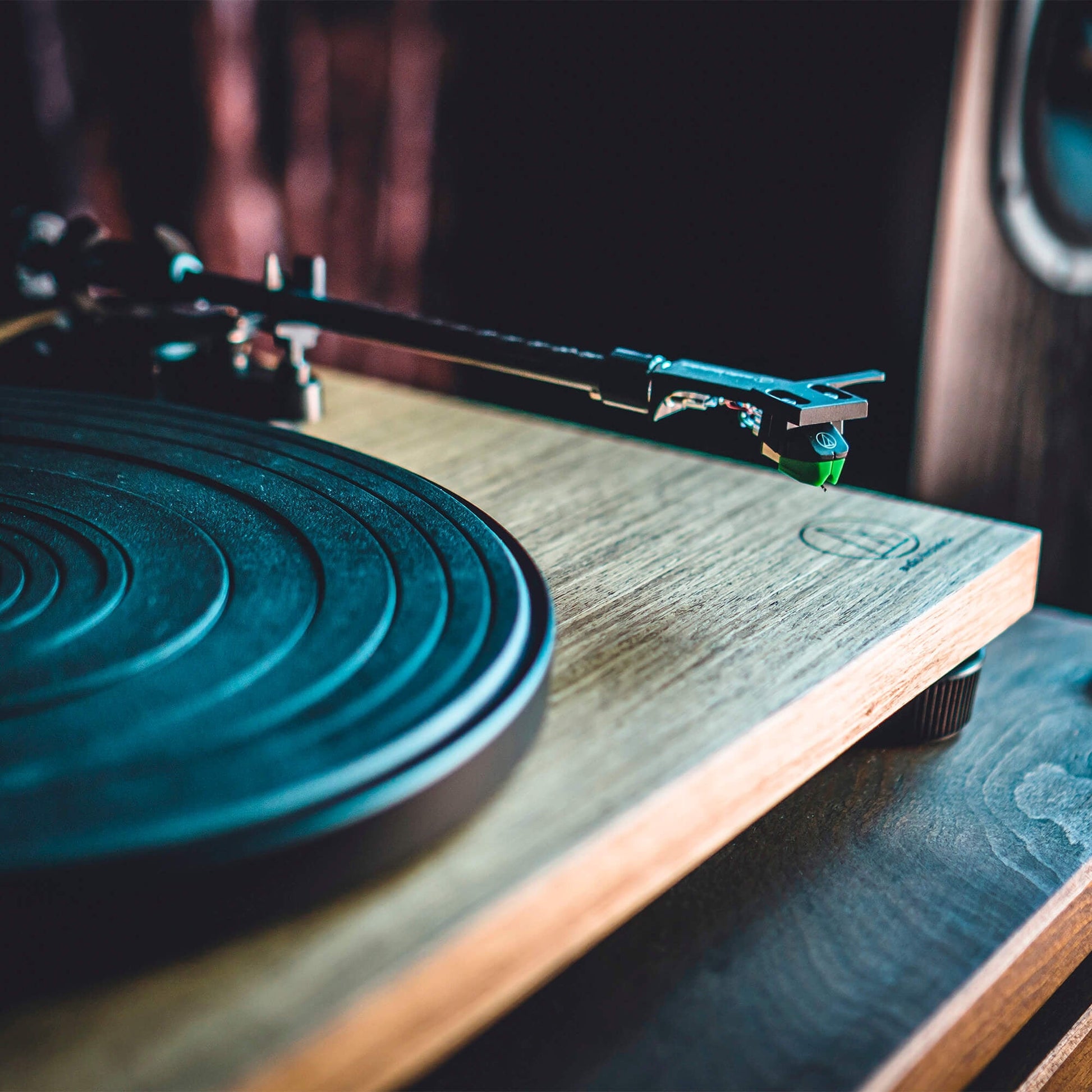 audio technica LPW40WN turntable with timber finish close up of arm and cartridge